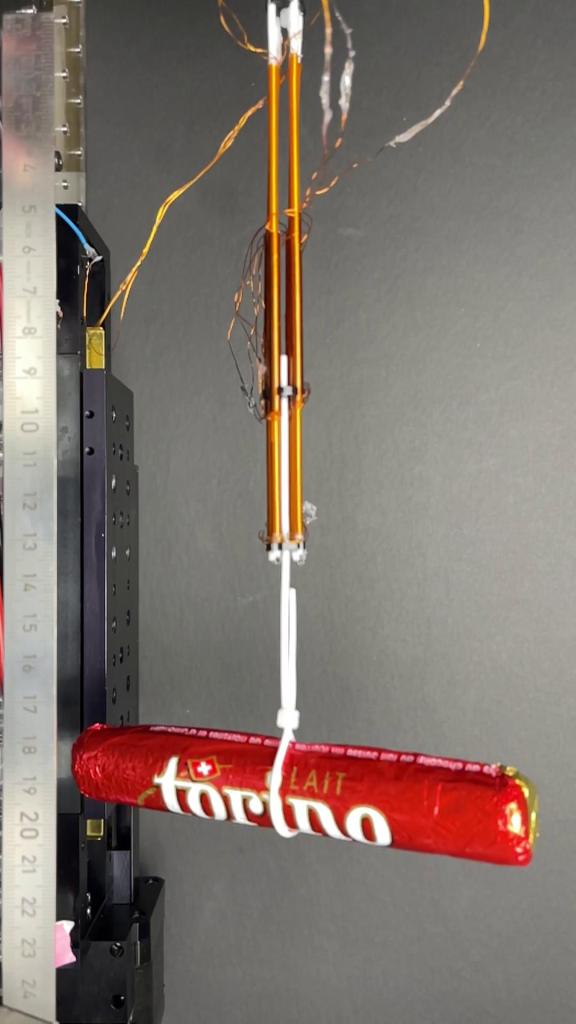 EPFL FiberMotor laboratory demonstration lifting a chocolate bar.