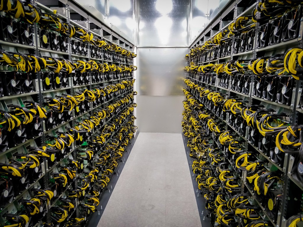 Rows of Bitcoin mining hardware inside Argo Blockchain's Mirabel mining facility.