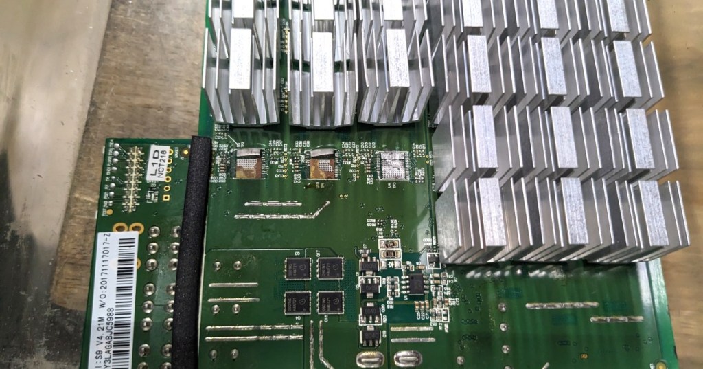 Close-up of a Bitcoin mining ASIC chip mounted on mining hardware, representing the chips installed across ASIC hashboards.