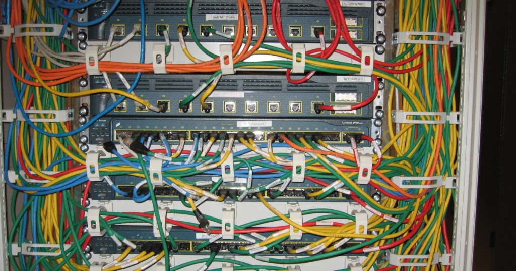 Cisco Catalyst network switches in a live rack, representing SNMP monitoring of network infrastructure around Bitcoin mining operations.