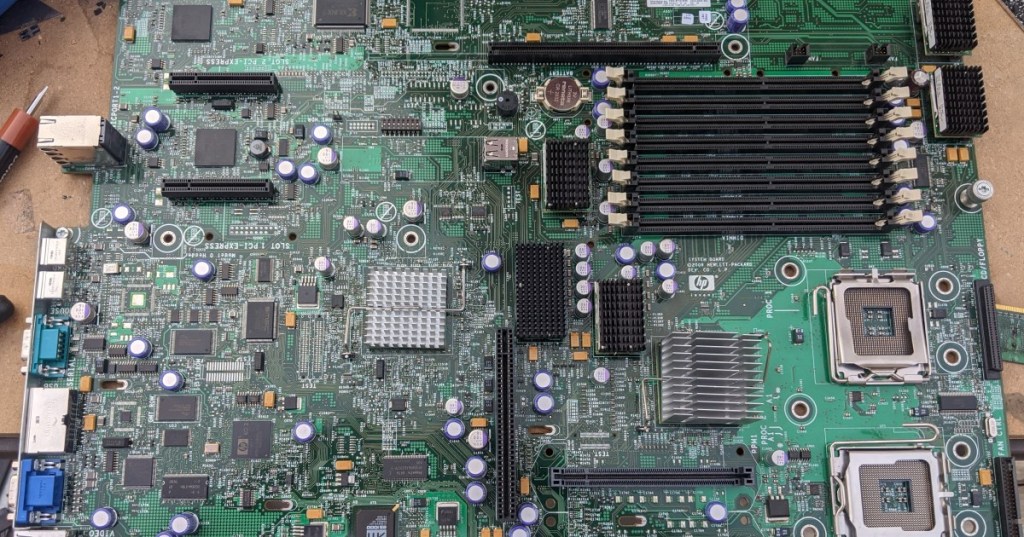 Top-down photograph of a dual-socket server motherboard representing the physical CPU hardware shared by virtual CPUs.