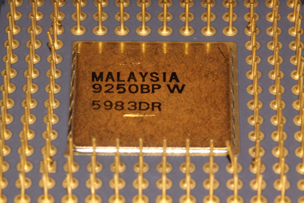Close-up photograph of a physical CPU package, representing the processor resources a hypervisor schedules among virtual CPUs.