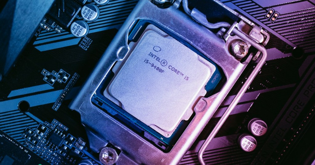 Realistic computer motherboard and CPU hardware representing memory buffers, queues, and data flow between devices and the processor.