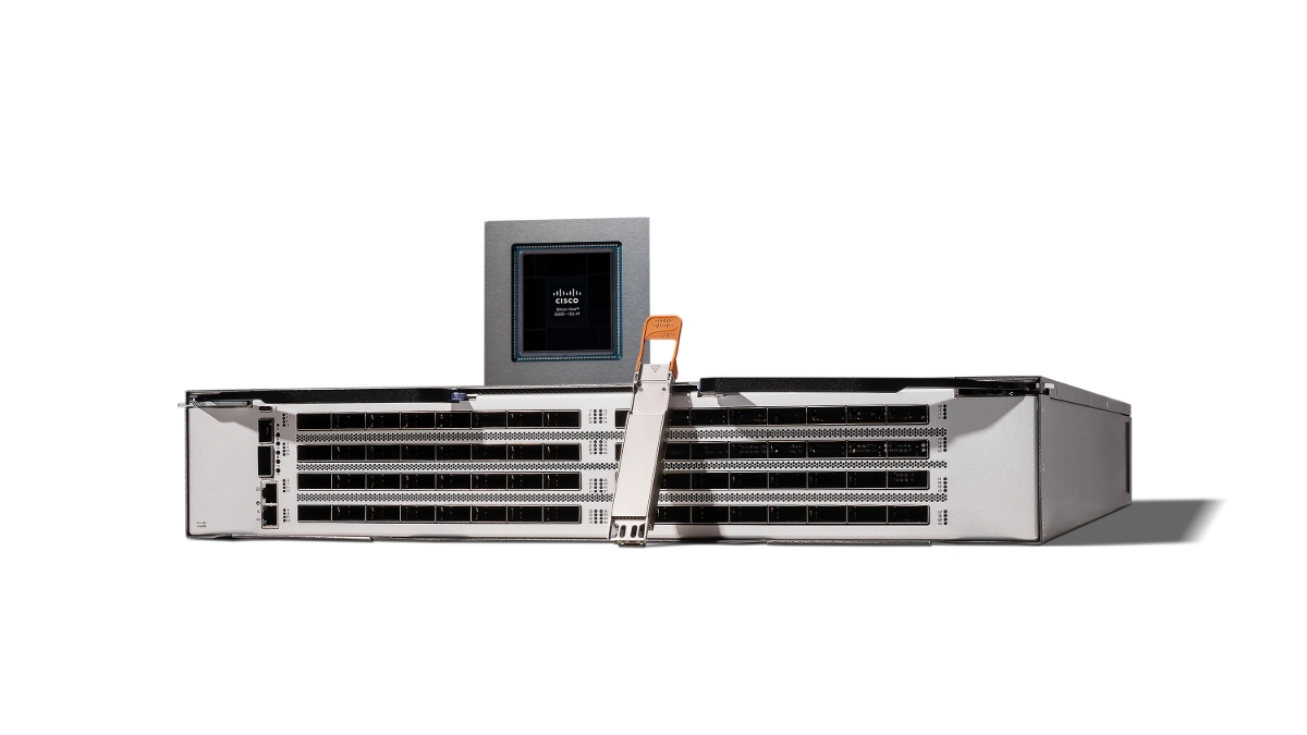 Cisco Silicon One G300 processor photographed with a rack-mounted network switch and optical module