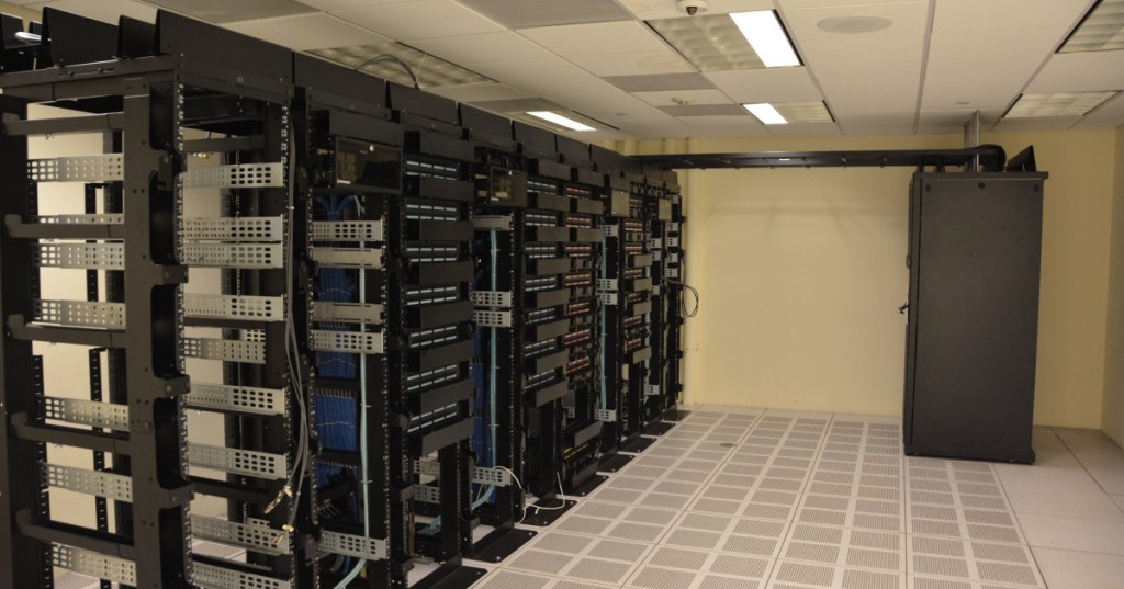 Rows of server racks inside a modern data center.