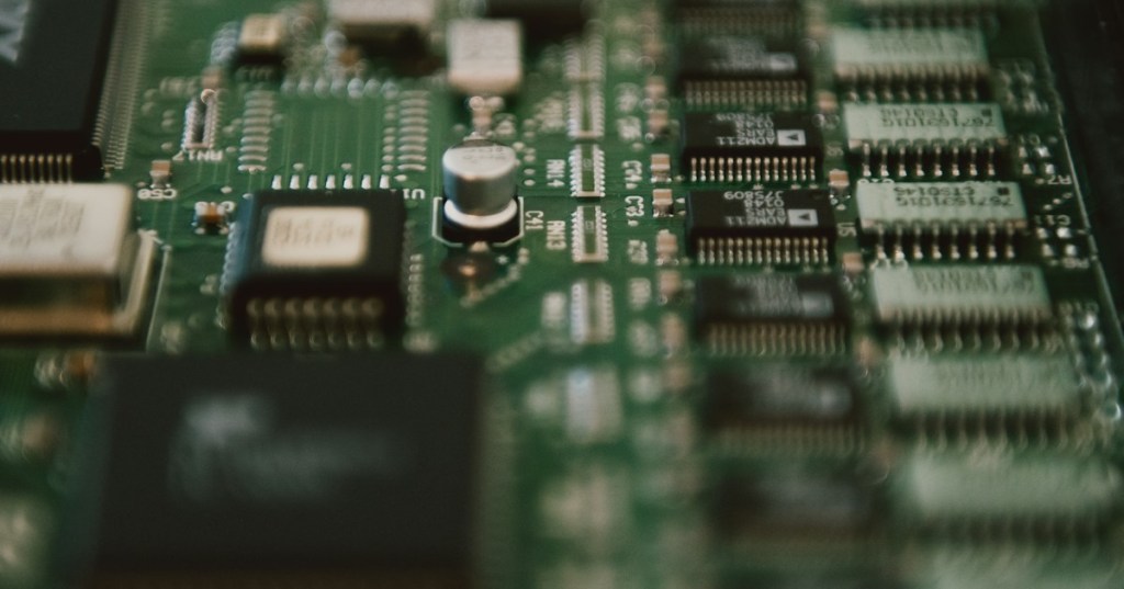 Close-up of a PCIe expansion card circuit board representing direct memory access between hardware devices and system memory.