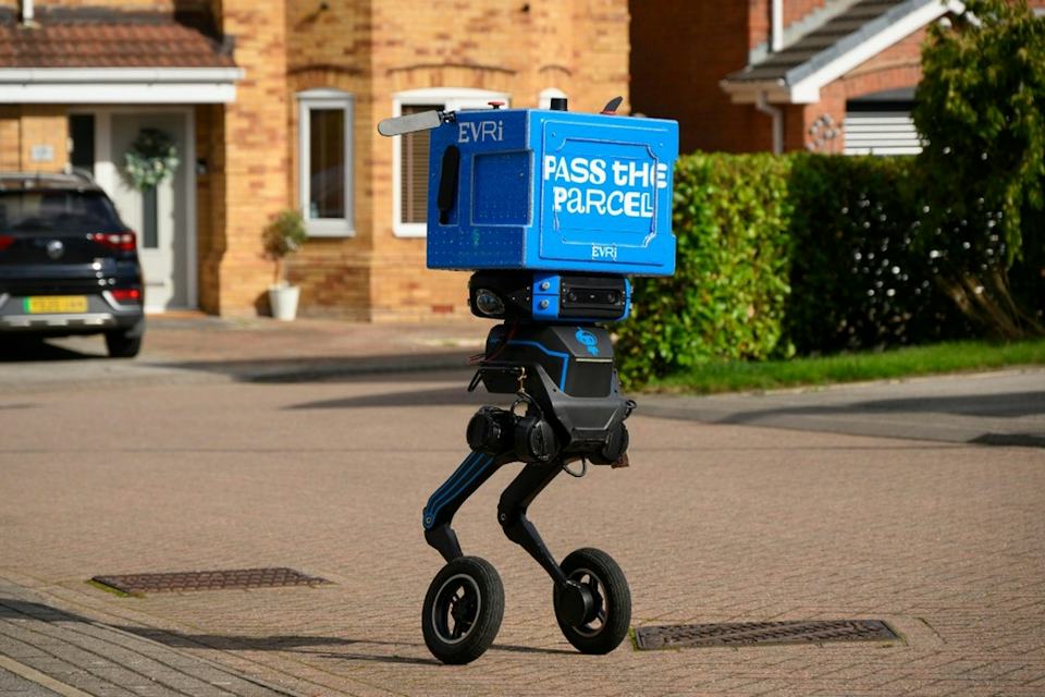 Evri's two-legged Iris delivery robot traveling on a residential street in Barnsley, England.