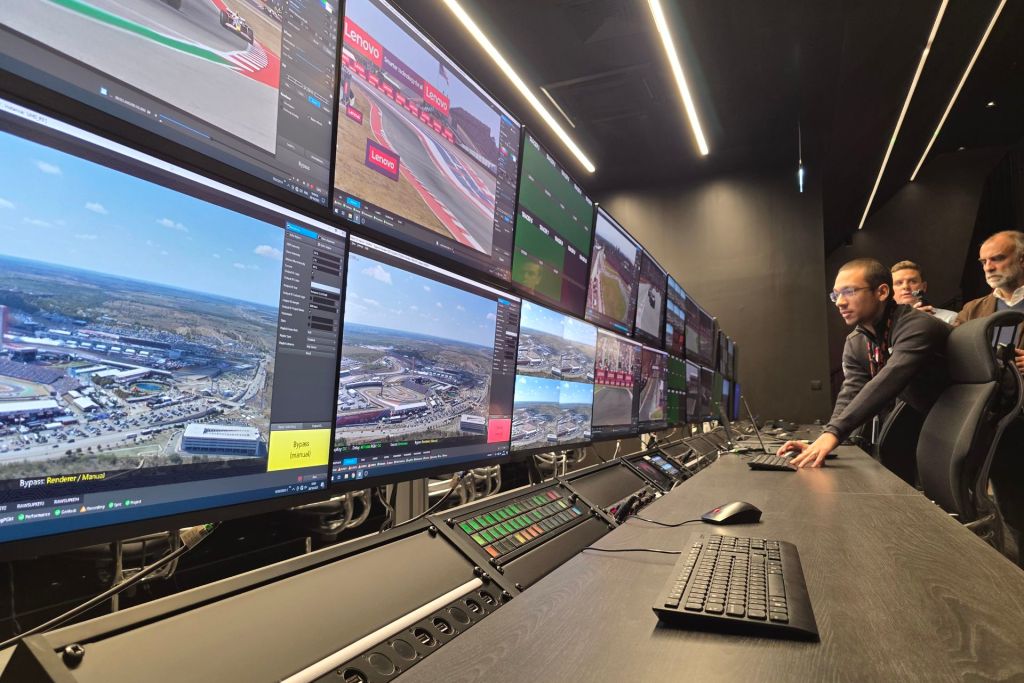 Formula 1 broadcast control room at Biggin Hill with multiple race feeds and operations screens.