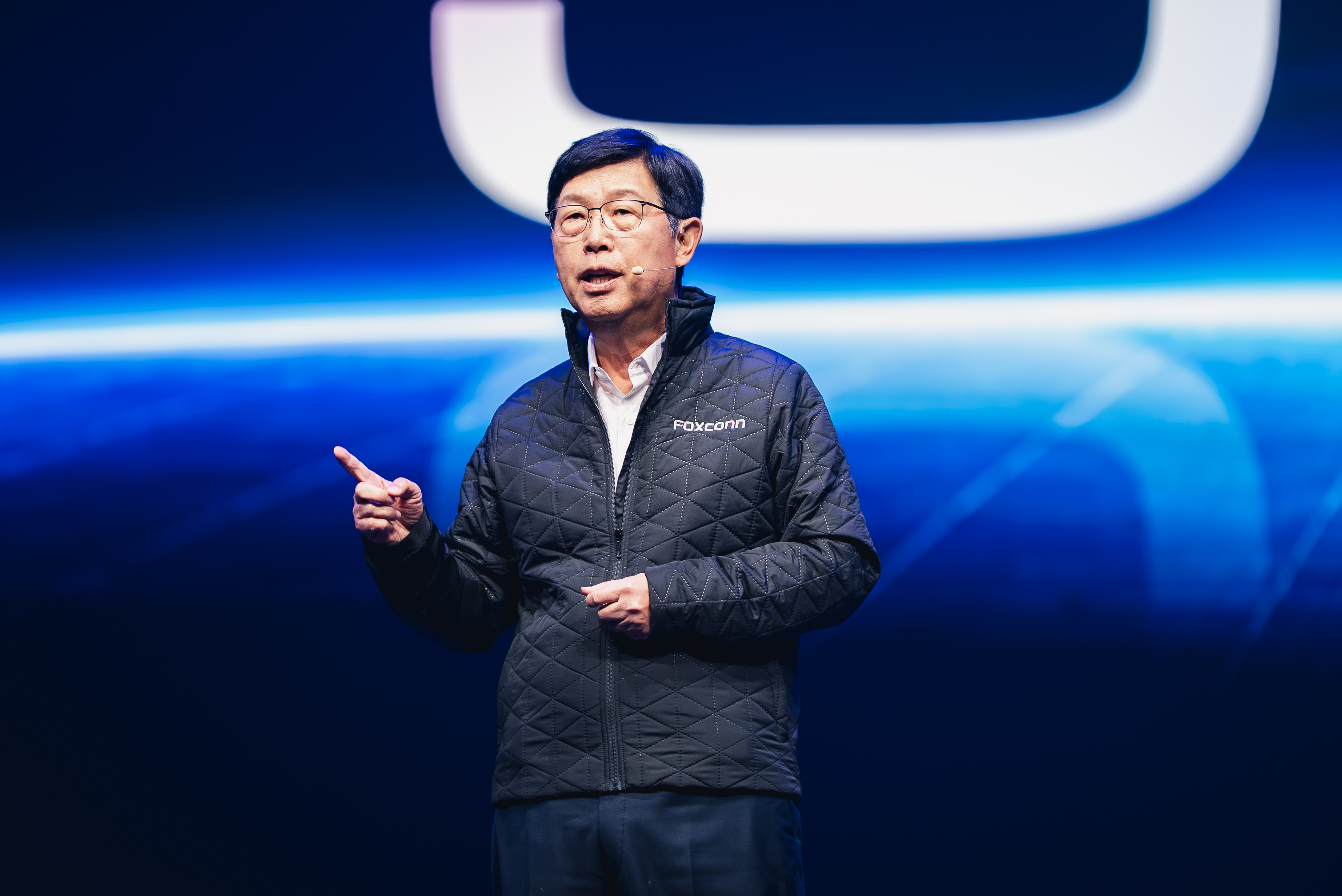 Foxconn Chairman Young Liu speaking on a blue-lit stage at Hon Hai Tech Day in Taipei on October 30 2026