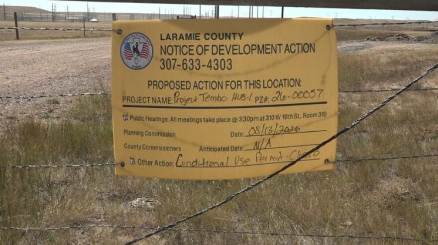 Yellow official Laramie County development notice for Google's Project Tembo photographed on a fence near the Cheyenne site