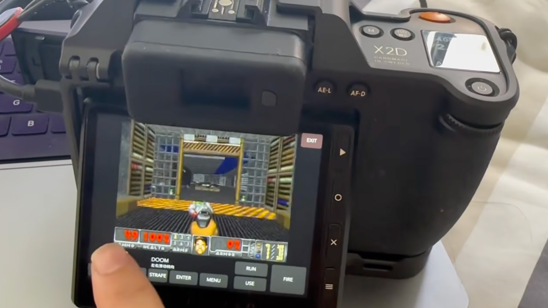 Real Hasselblad X2D camera running a Doom-derived game on its rear touchscreen