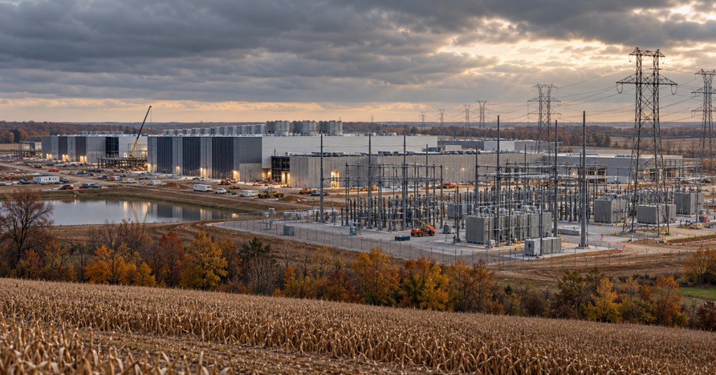 Conceptual photorealistic editorial scene of a large Indiana data center, electrical substation, transmission lines, and farmland