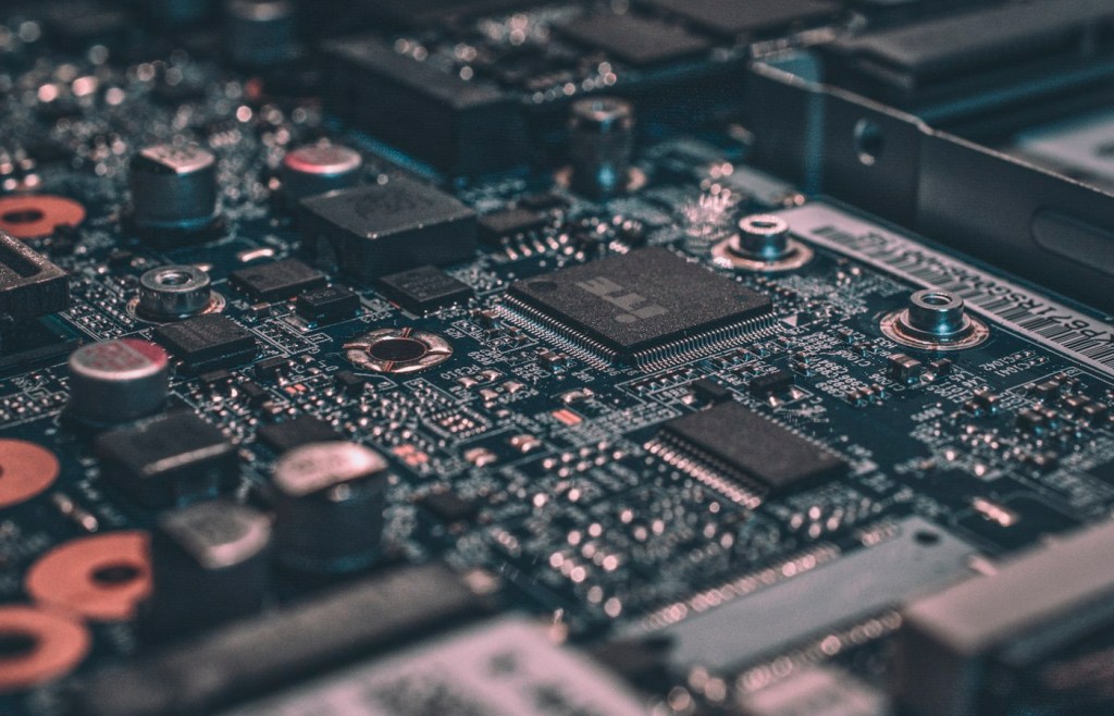 Macro photograph of computer circuit-board components representing hardware devices and interrupt signaling.