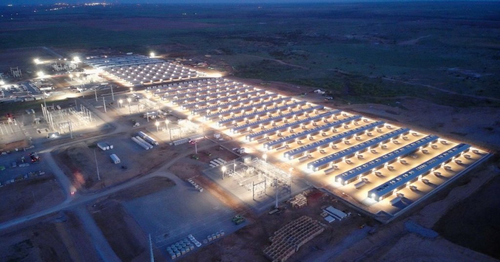 Nighttime aerial view of IREN's Childress, Texas Bitcoin mining facility with rows of illuminated mining containers and electrical infrastructure.