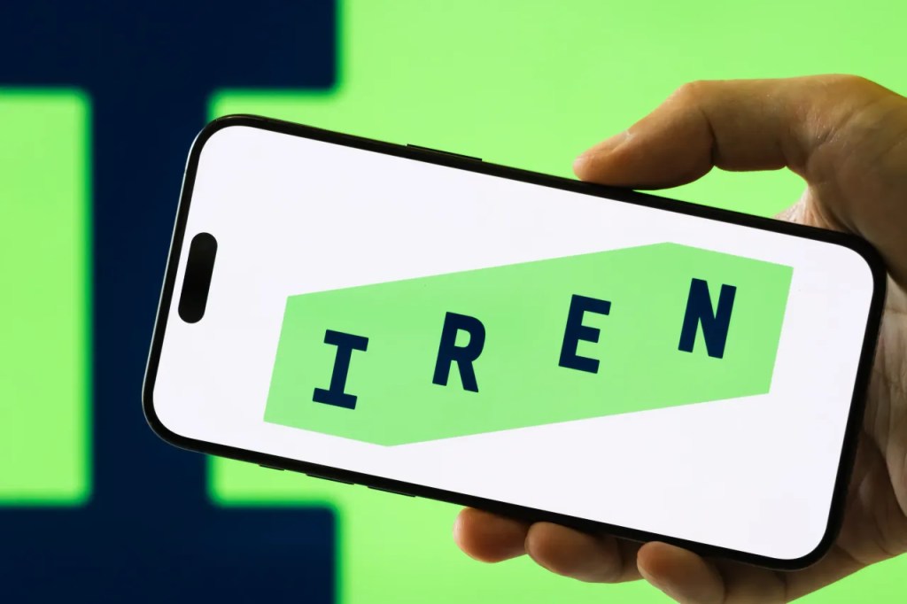 IREN logo displayed on a smartphone, illustrating IREN's NVIDIA AI infrastructure validation news