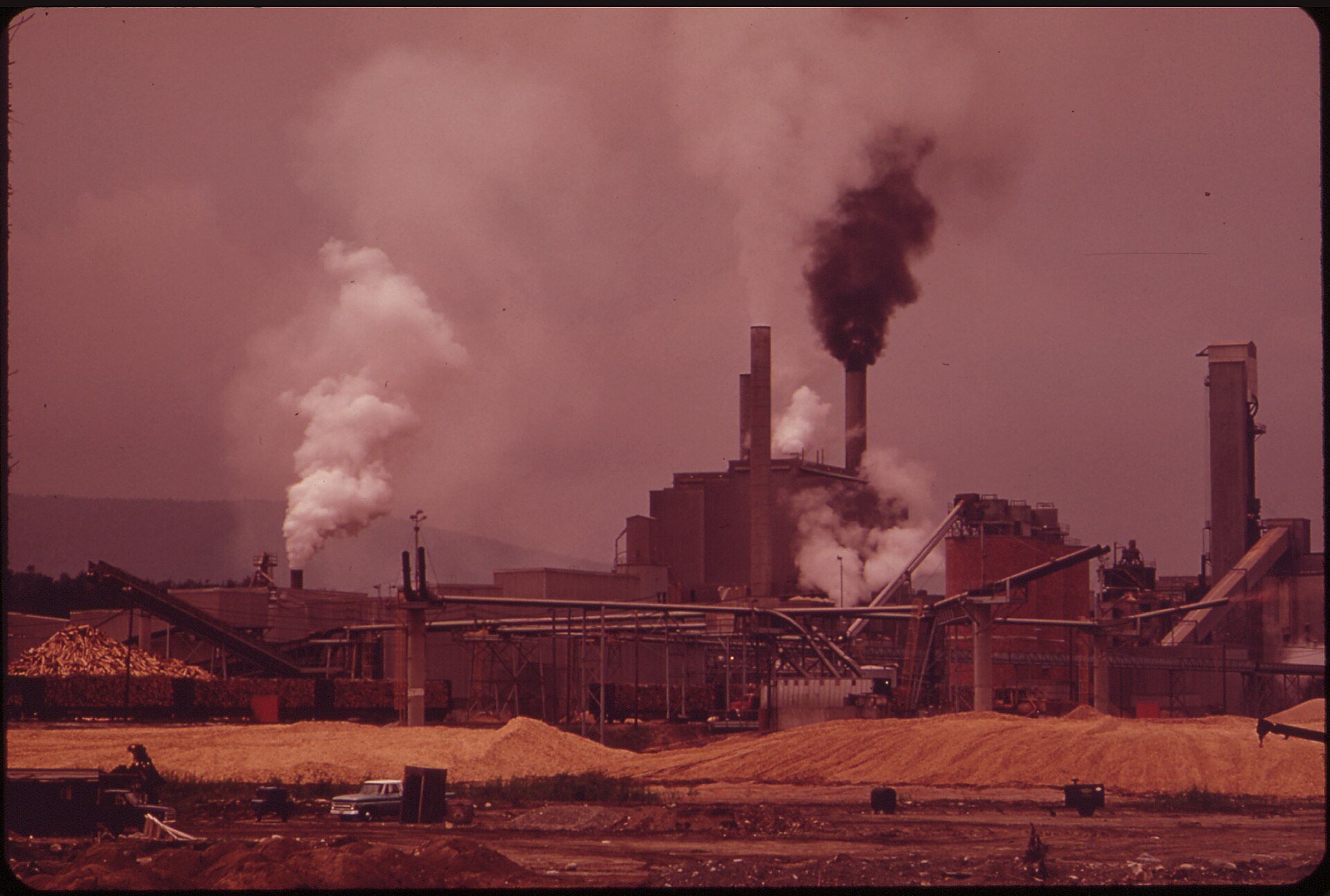 Archival National Archives photograph of paper mill industrial facilities in Jay, Maine, next to the Androscoggin River