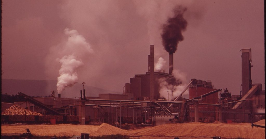 Historic public-domain 1973 photograph of the Androscoggin Paper Mill in Jay, Maine, connected to a former mill reuse proposal, showing its industrial site and river landscape
