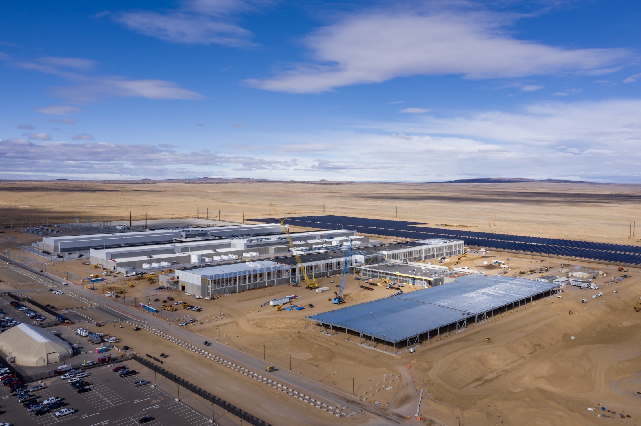 Aerial photograph of the Meta Los Lunas data center under construction with solar arrays in the surrounding desert