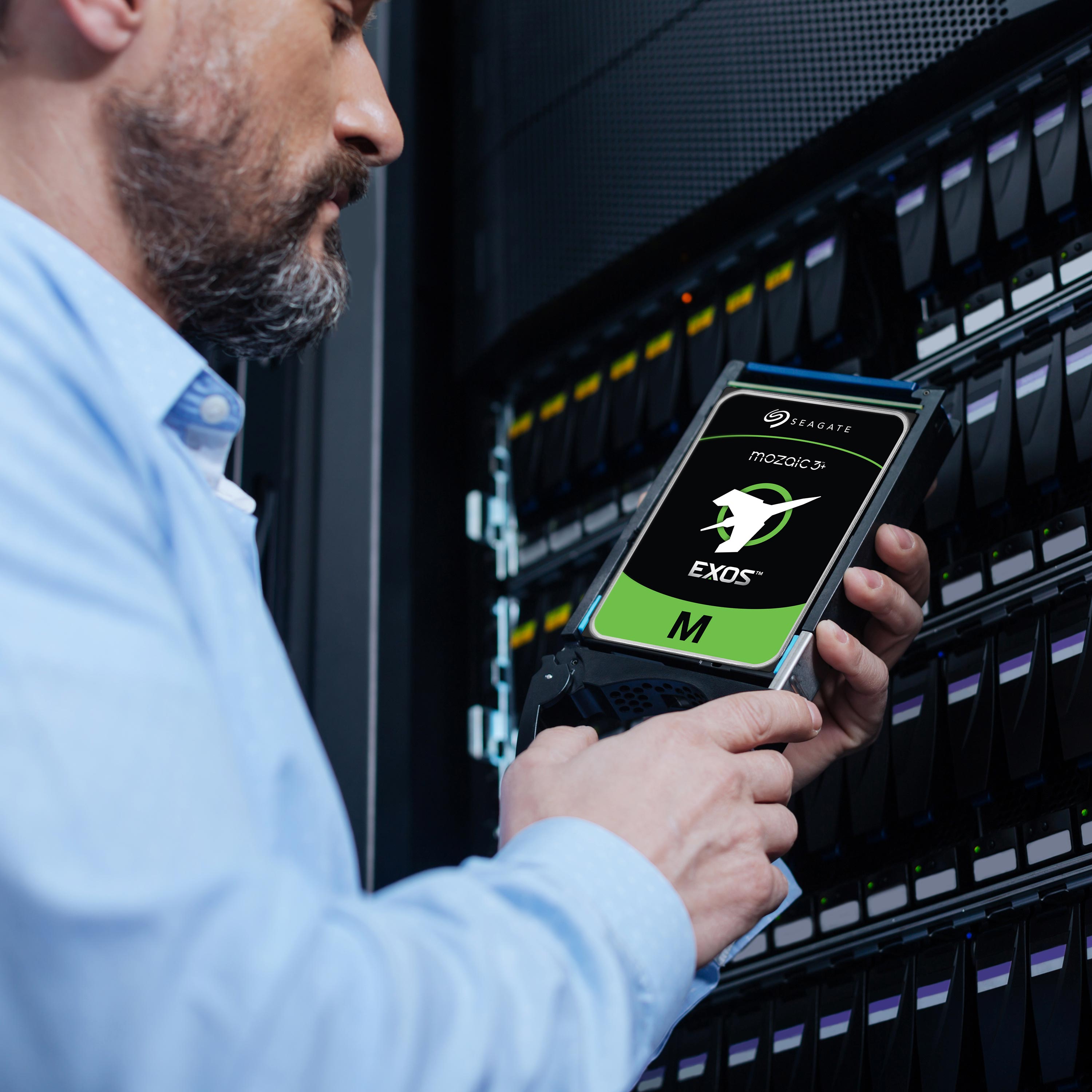 Official Seagate photograph of a technician with a Mozaic 3+ drive at an enterprise storage rack; earlier generation used for platform context