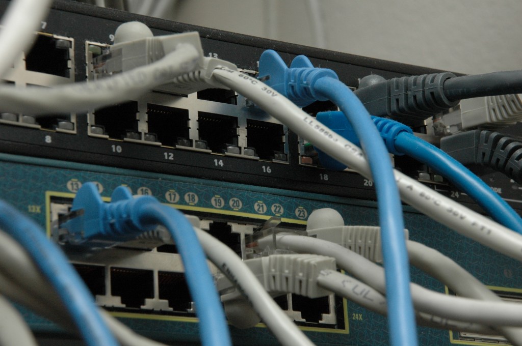 Two network switches connected with CAT5 Ethernet cables, representing the network infrastructure monitored with SNMP.