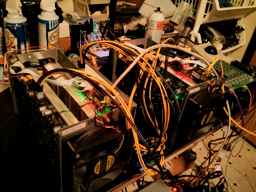 A group of Bitcoin mining machines, representing ASIC hardware configured to connect to a mining pool.