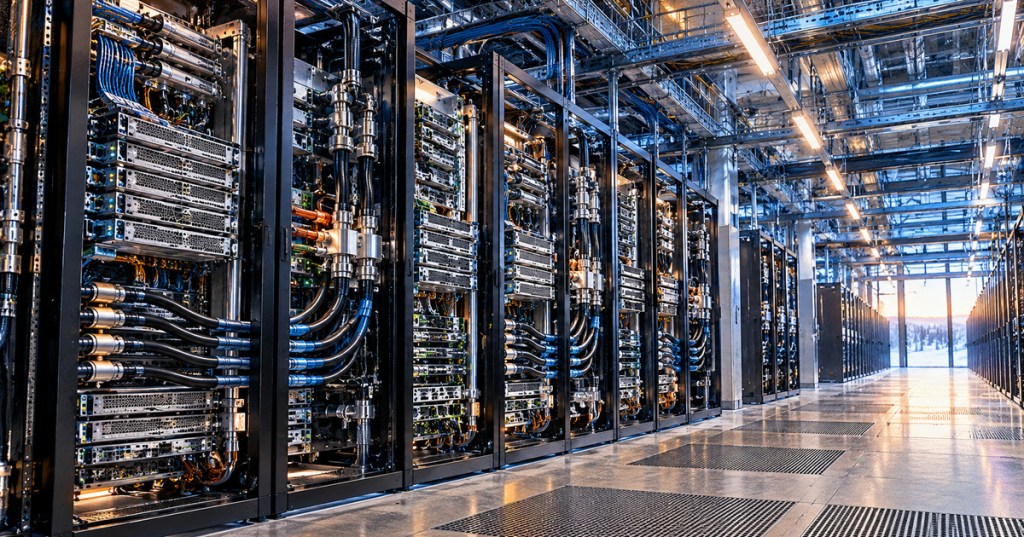 Open liquid-cooled AI server racks in a modern data center, representing growth in OCP-recognized infrastructure spending.