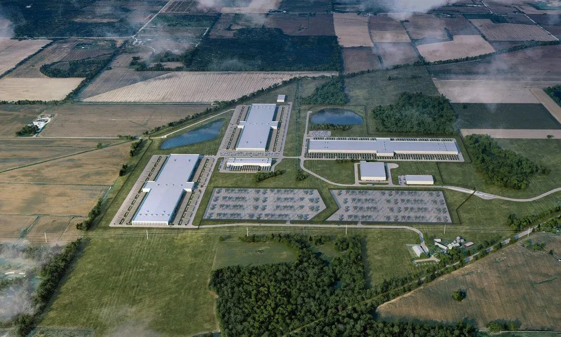 Aerial conceptual visualization of several long data hall buildings surrounded by forest, fields, access roads and ponds