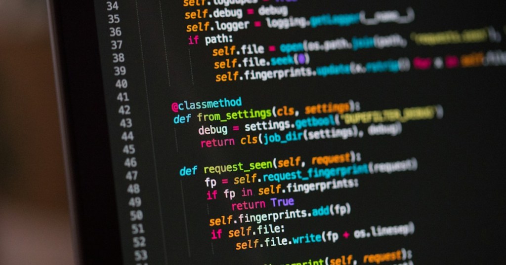 Realistic photograph of Python code on a computer screen representing time-based log rotation and scheduled log-file rollover.