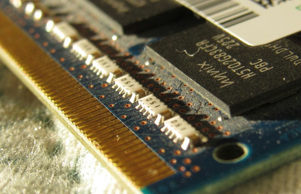 Close-up photograph of a computer RAM module used to illustrate physical memory.