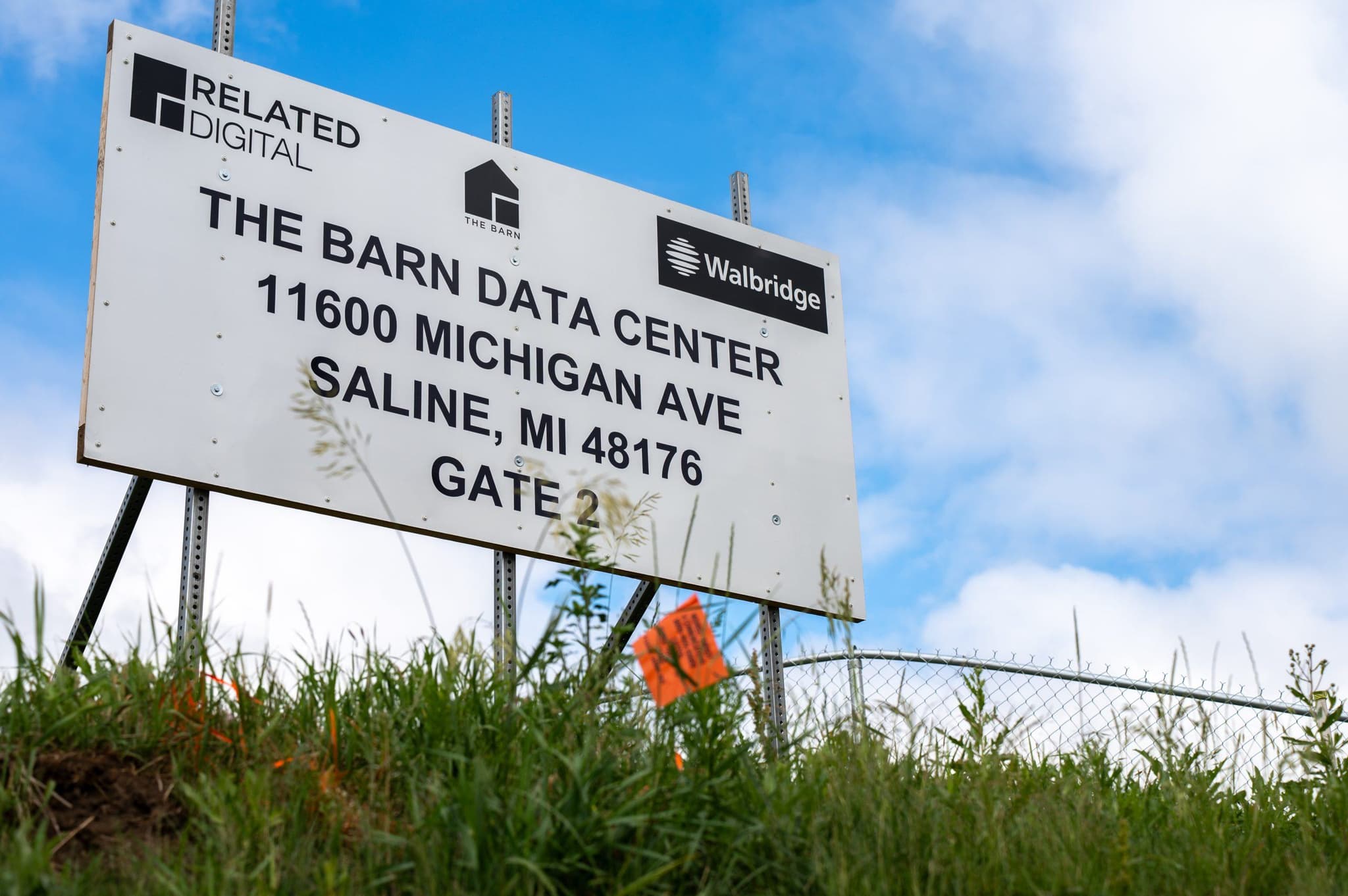 Documentary photograph of The Barn project construction sign along Michigan Avenue in Saline Township identifying Related Digital and Walbridge