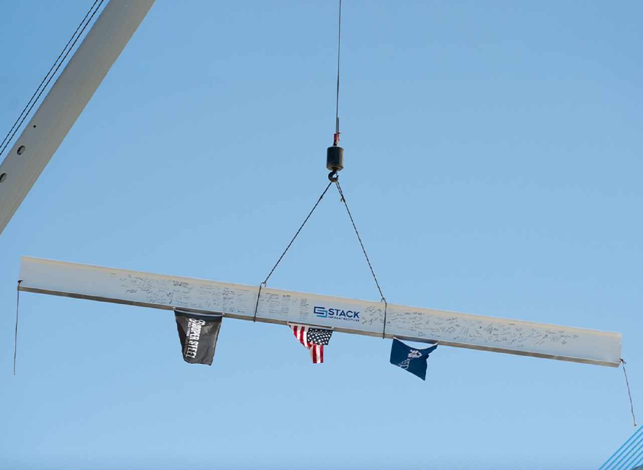 Steel beam lifted by a crane during STACK Infrastructure's first-building topping-out ceremony in Stafford County in 2026