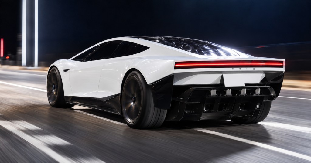 White next-generation Tesla Roadster accelerating at night, viewed from the rear three-quarter angle with a full-width red taillight and black aerodynamic rear diffuser.