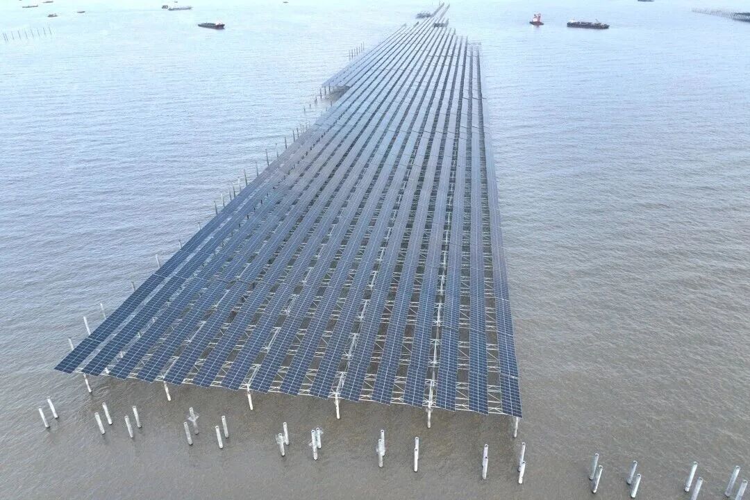 Rows of photovoltaic solar panels installed above the shallow tidal flats at Tianwan, Jiangsu, China