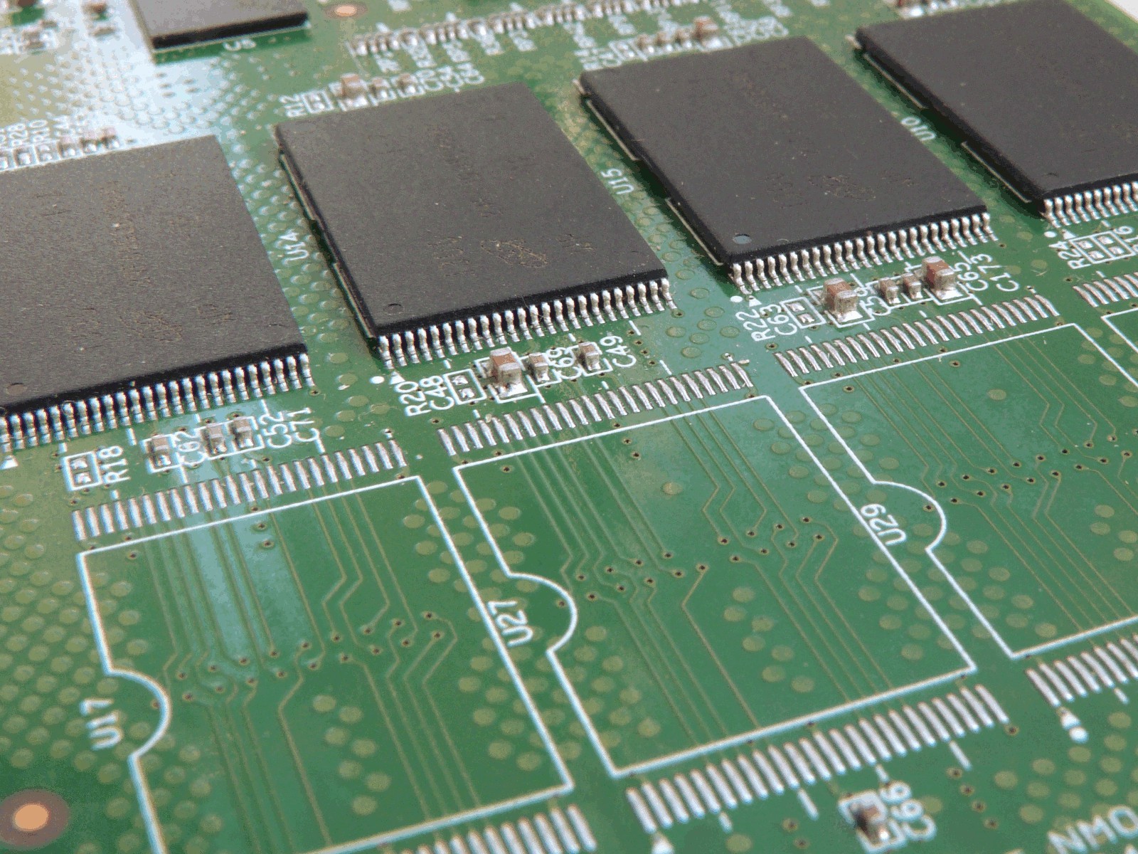 Photograph showing a soldered TSOP integrated circuit behind an empty matching land pattern with two rows of exposed copper pads.