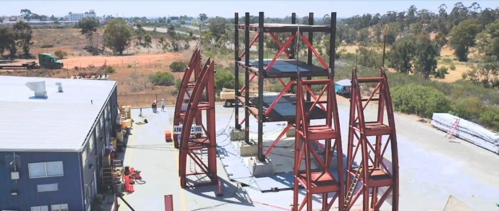 Outdoor view of the UC San Diego shake table facility with red steel support frames.
