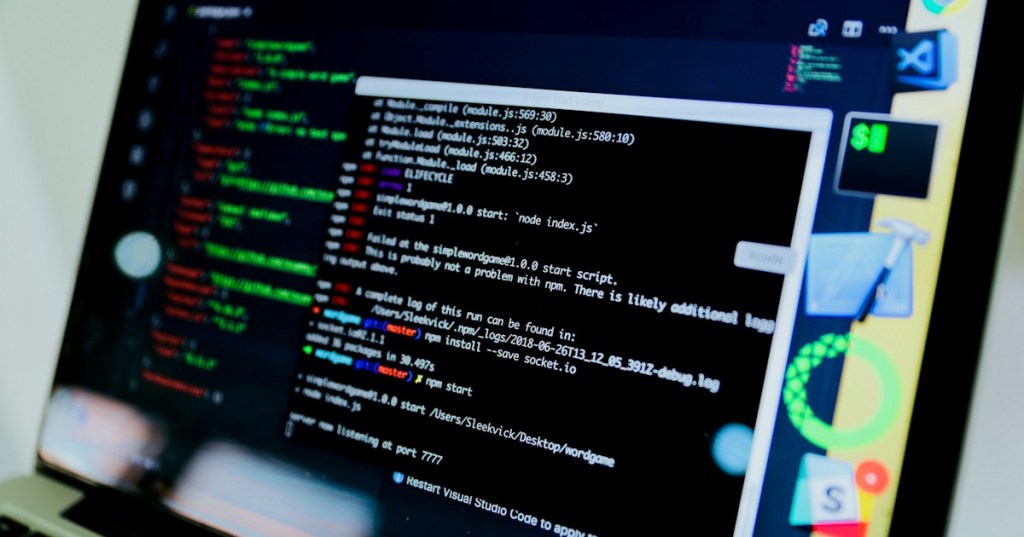 Close-up editorial photograph of a laptop displaying a command-line interface.